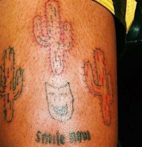 “Smile Mood” and three Cactus Plants on his Left Elbow 